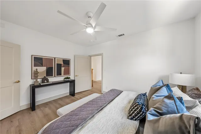 a bedroom with a bed and flat screen tv