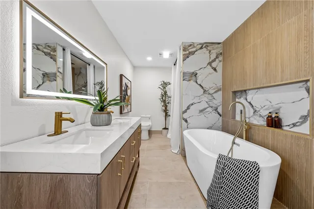 a bathroom with a sink a mirror and a bathtub