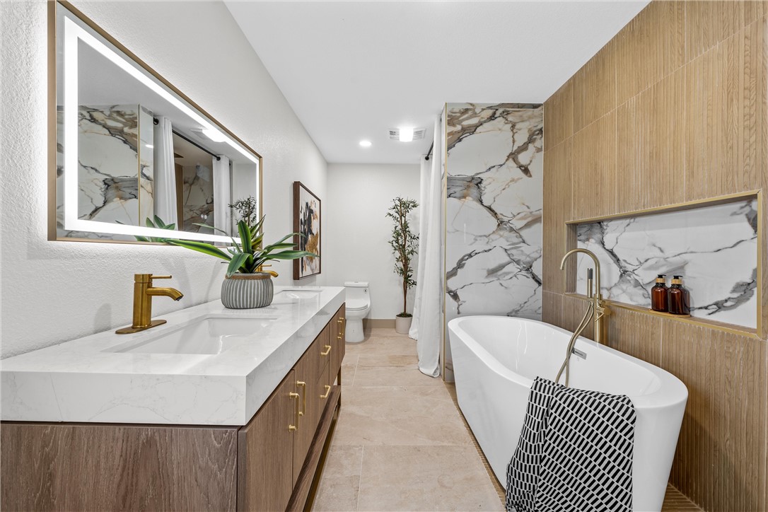2211 Morrow Avenue Waco, TX 76707 - Photo 19 of 39 a bathroom with a sink a mirror and a bathtub