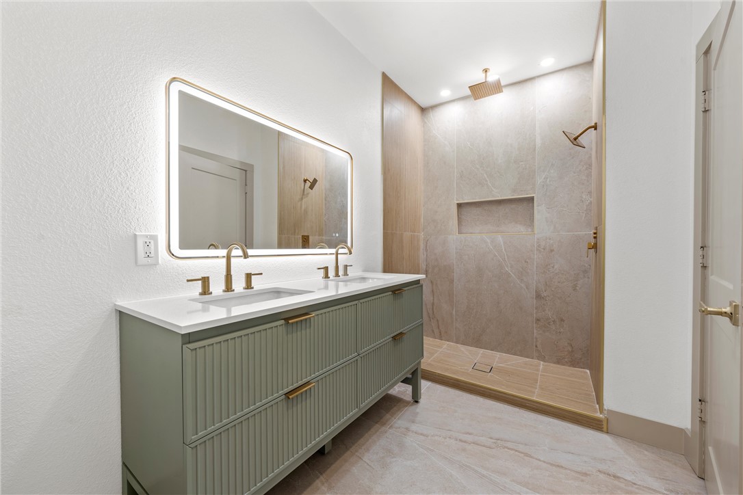 2211 Morrow Avenue Waco, TX 76707 - Photo 22 of 39 a bathroom with a sink mirror and a shower