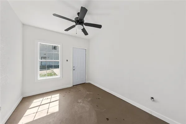 a view of a big room with wooden floor and windows