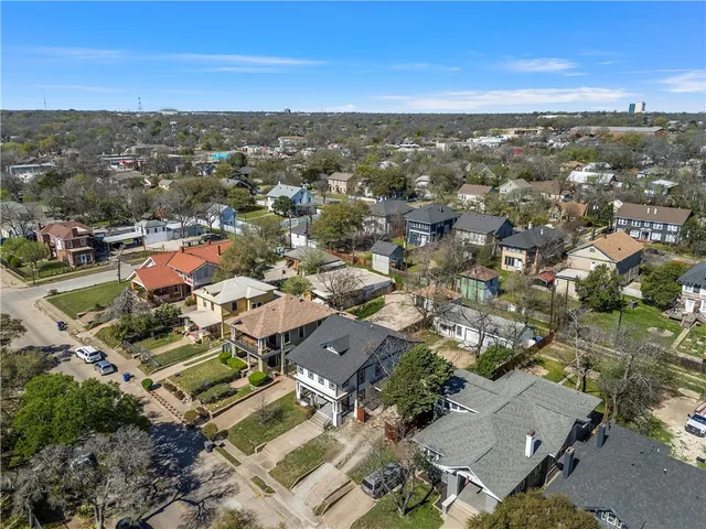 an aerial view of residential houses with city view