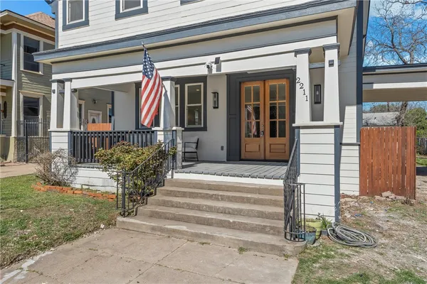 a view of a entrance door of the house with a fountain