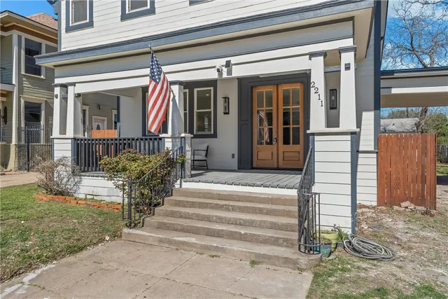 a view of a entrance door of the house with a fountain
