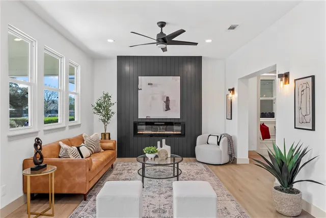 a living room with furniture potted plant and a chandelier