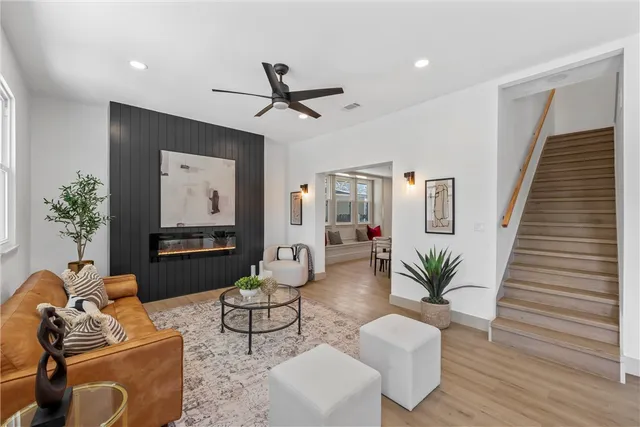 a living room with furniture and a wooden floor