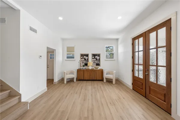 a bedroom with furniture and wooden floor