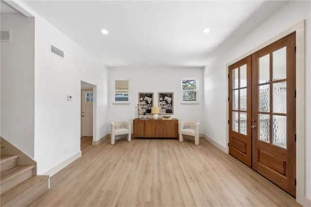 a bedroom with furniture and wooden floor