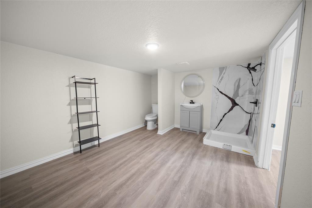 823 Clark Street Tyler, TX 75701 - Photo 13 of 17 an empty room with wooden floor and white walls