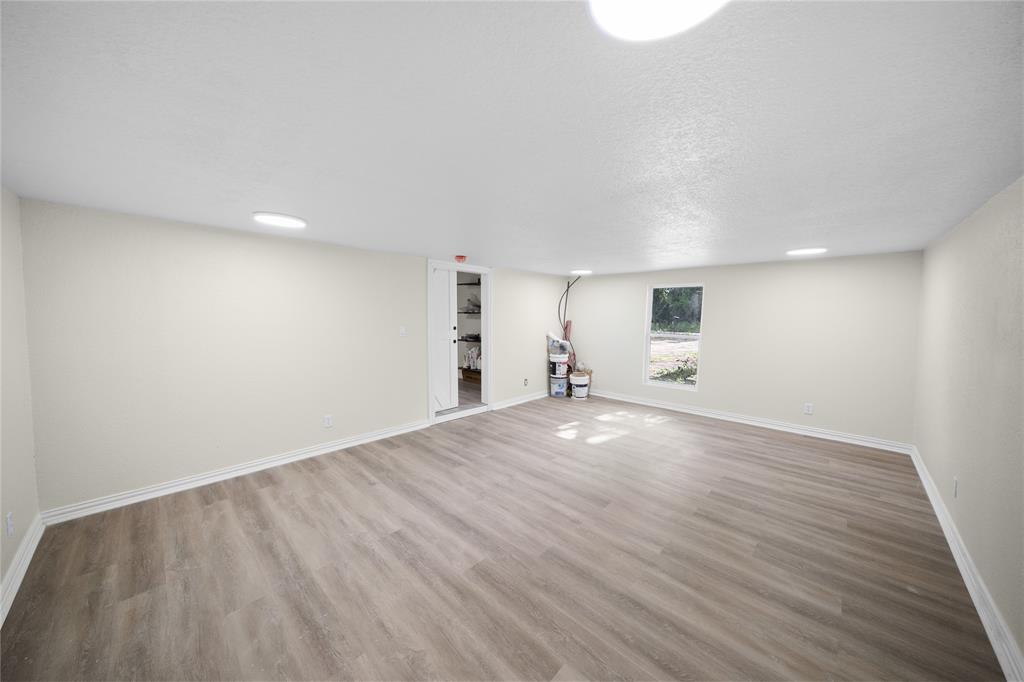 823 Clark Street Tyler, TX 75701 - Photo 14 of 17 an empty room with wooden floor and windows