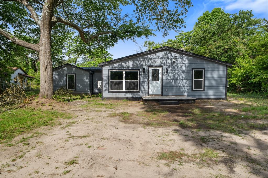823 Clark Street Tyler, TX 75701 - Photo 16 of 17 a house with trees in the background