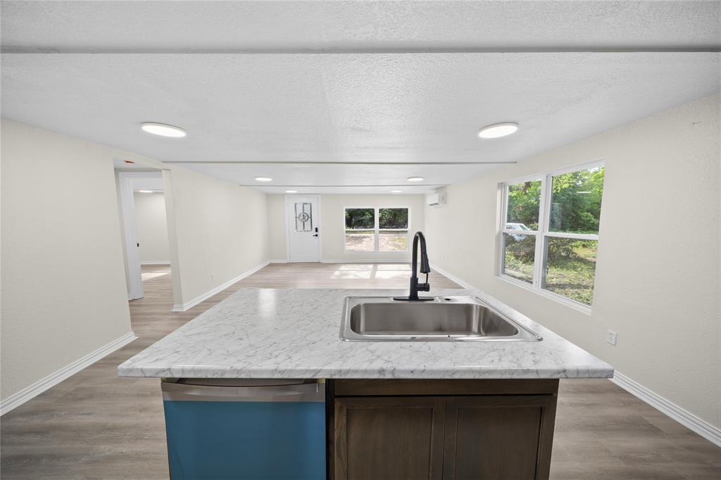823 Clark Street Tyler, TX 75701 - Photo 3 of 17 a kitchen with granite countertop a sink and a window