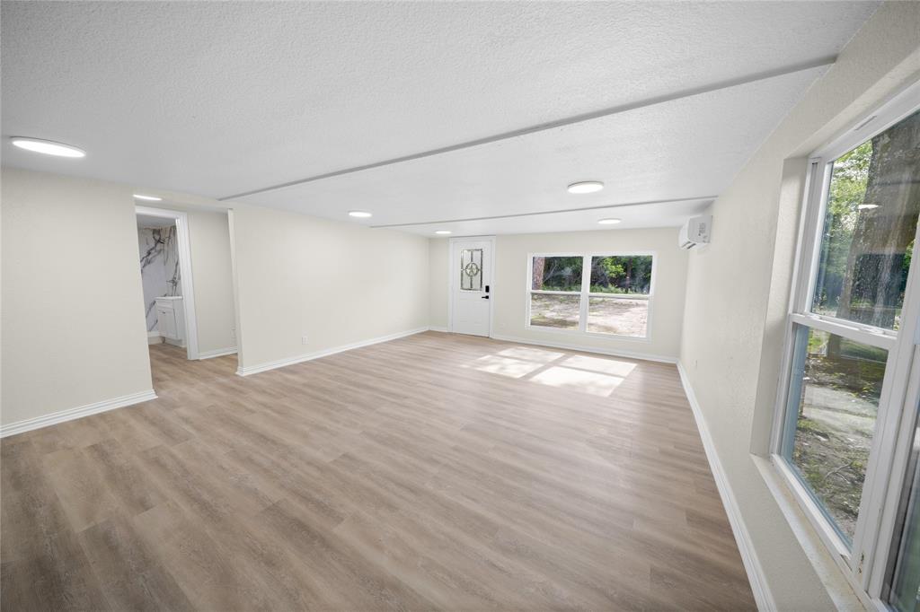 823 Clark Street Tyler, TX 75701 - Photo 5 of 17 a view of empty room with wooden floor and fan