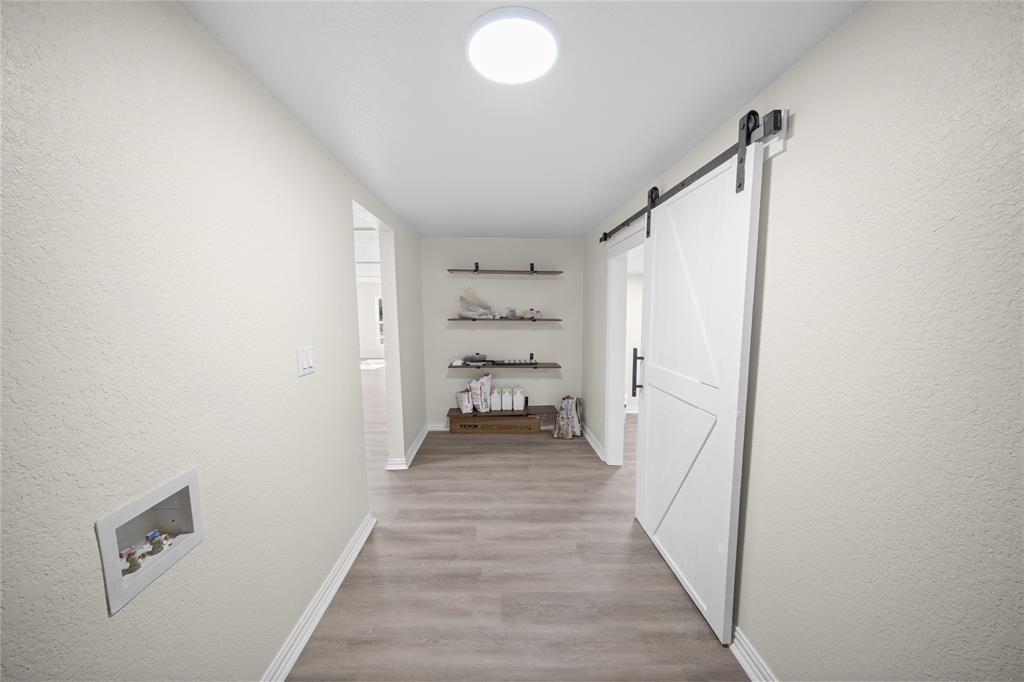 823 Clark Street Tyler, TX 75701 - Photo 7 of 17 a view of a hallway with wooden floor and closet