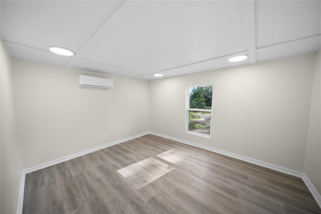 823 Clark Street Tyler, TX 75701 - Photo 8 of 17 wooden floor in an empty room with a window