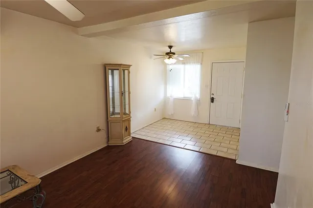 an empty room with wooden floor and closet