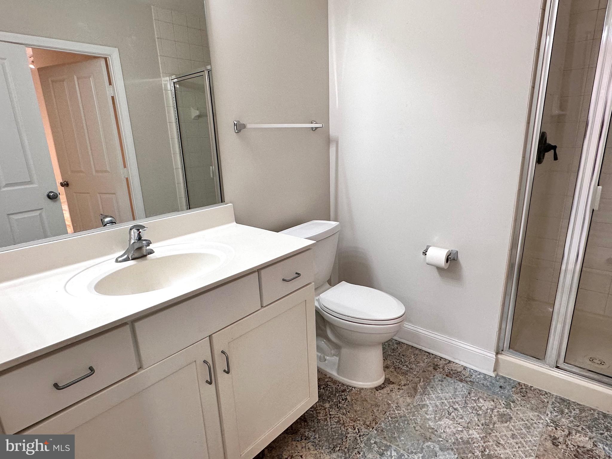 1201 North Garfield Street, Unit 408 Arlington, VA 22201 - Photo 14 of 26 a bathroom with a sink a toilet a mirror and shower