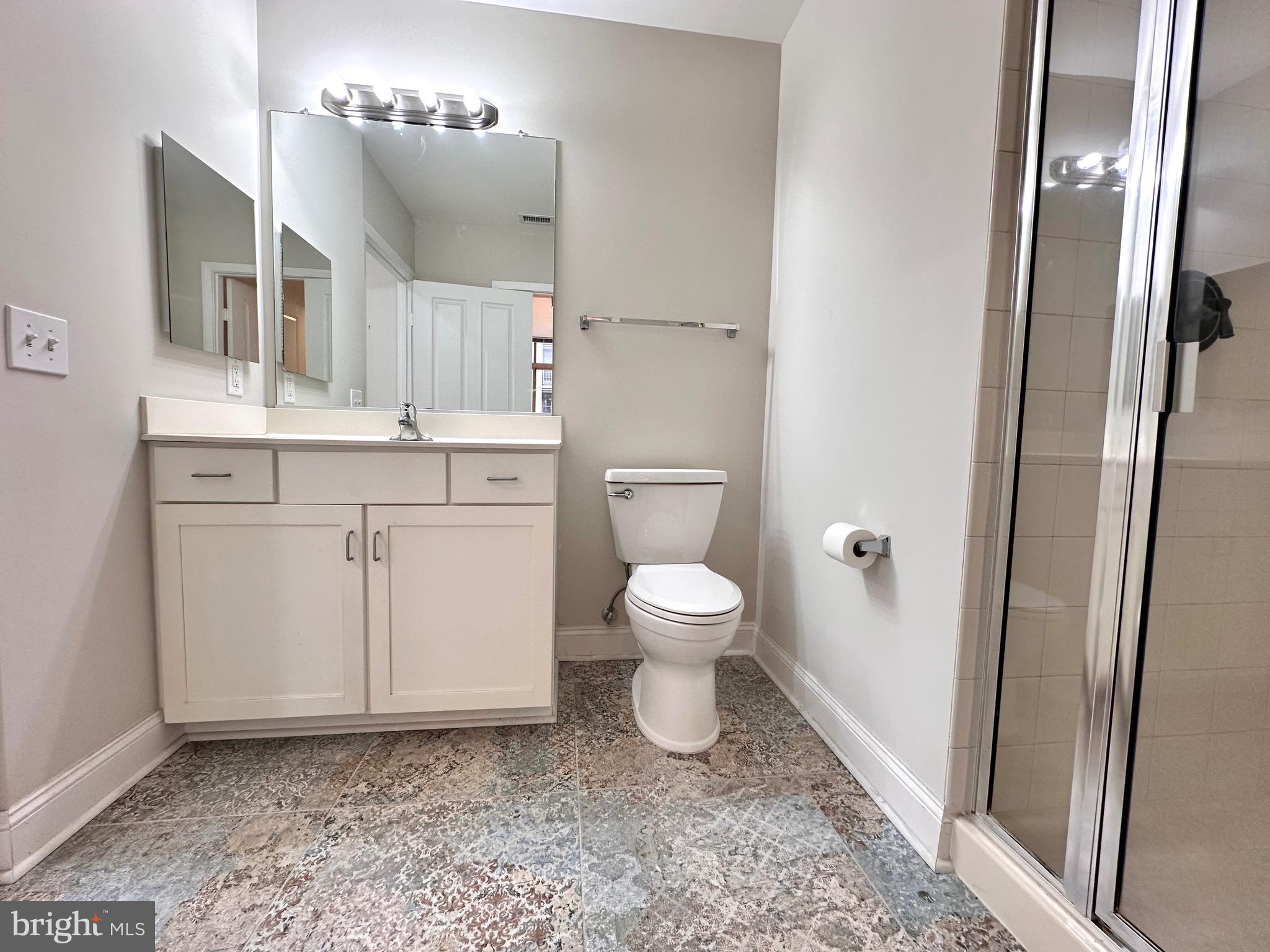 1201 North Garfield Street, Unit 408 Arlington, VA 22201 - Photo 15 of 26 a bathroom with a sink a toilet and mirror