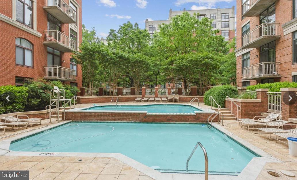 1201 North Garfield Street, Unit 408 Arlington, VA 22201 - Photo 18 of 26 a view of a swimming pool with a lounge chairs