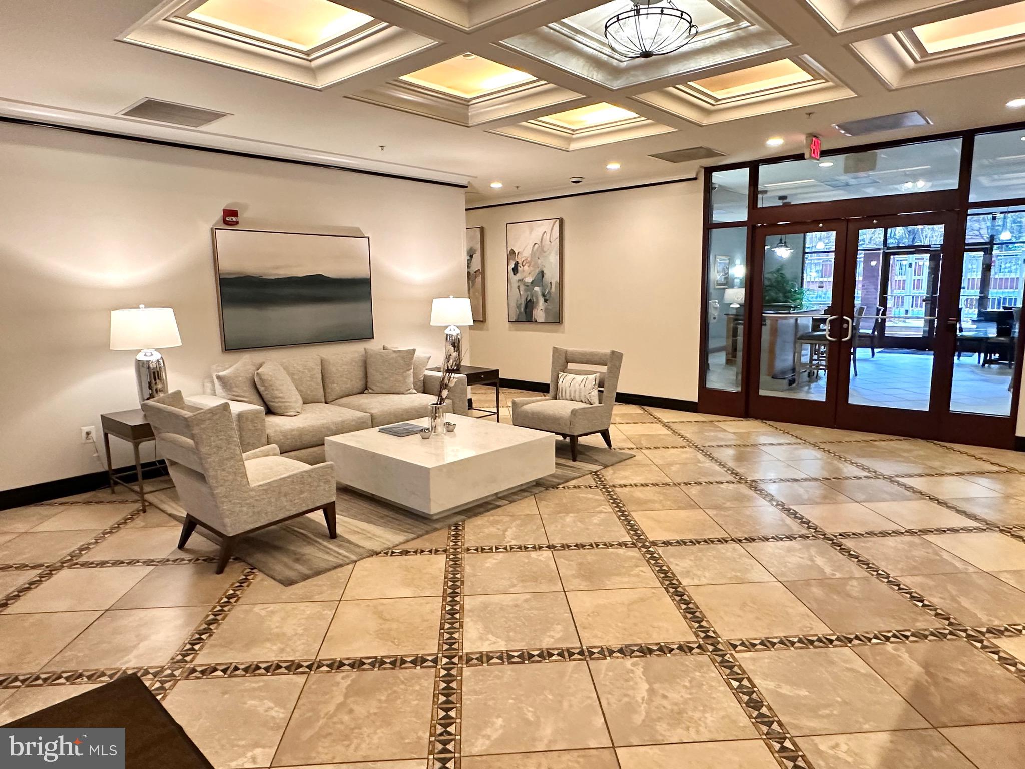 1201 North Garfield Street, Unit 408 Arlington, VA 22201 - Photo 21 of 26 a living room with a couch and a rug