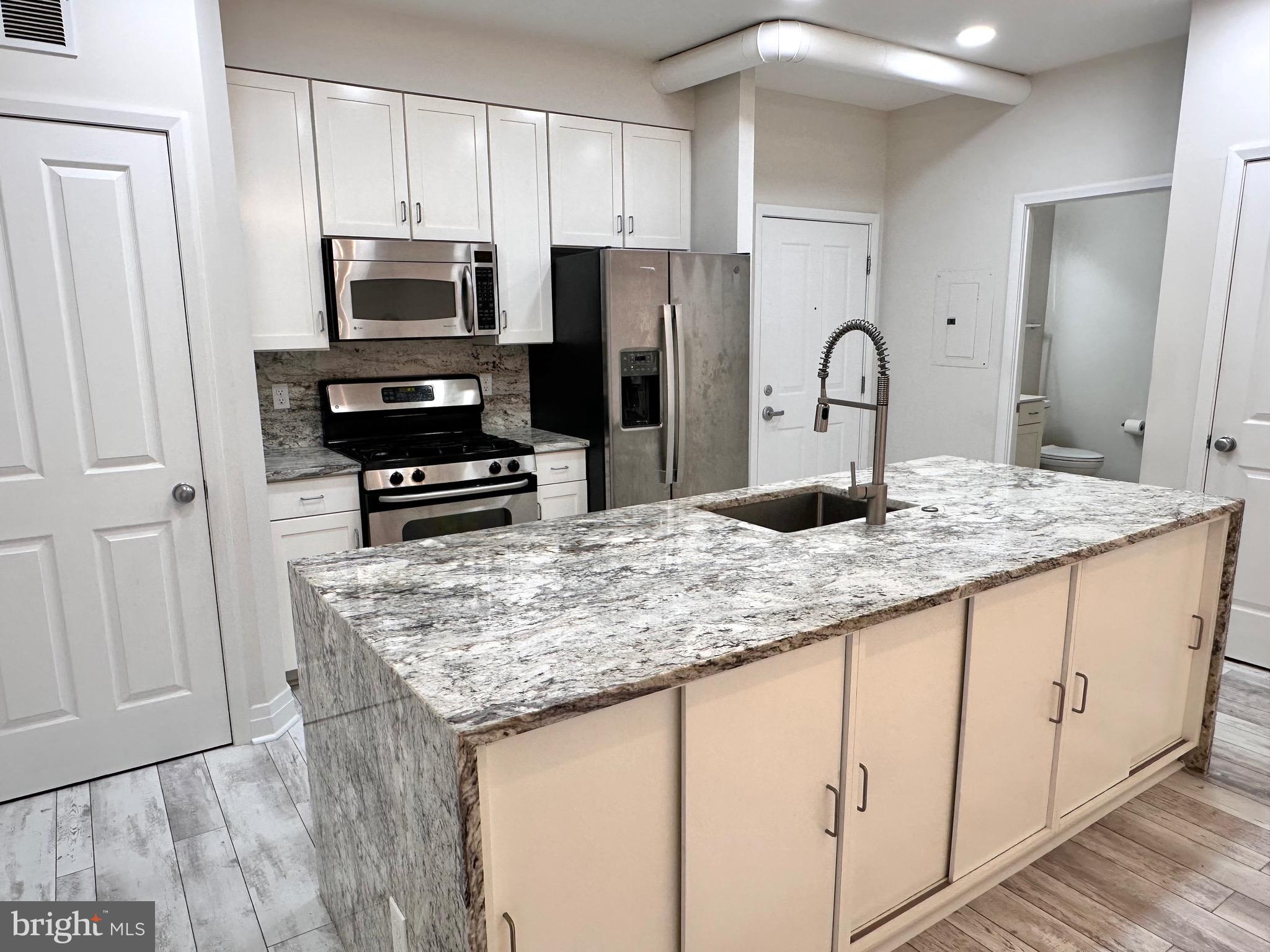 1201 North Garfield Street, Unit 408 Arlington, VA 22201 - Photo 2 of 26 a kitchen with granite countertop a sink stove and refrigerator