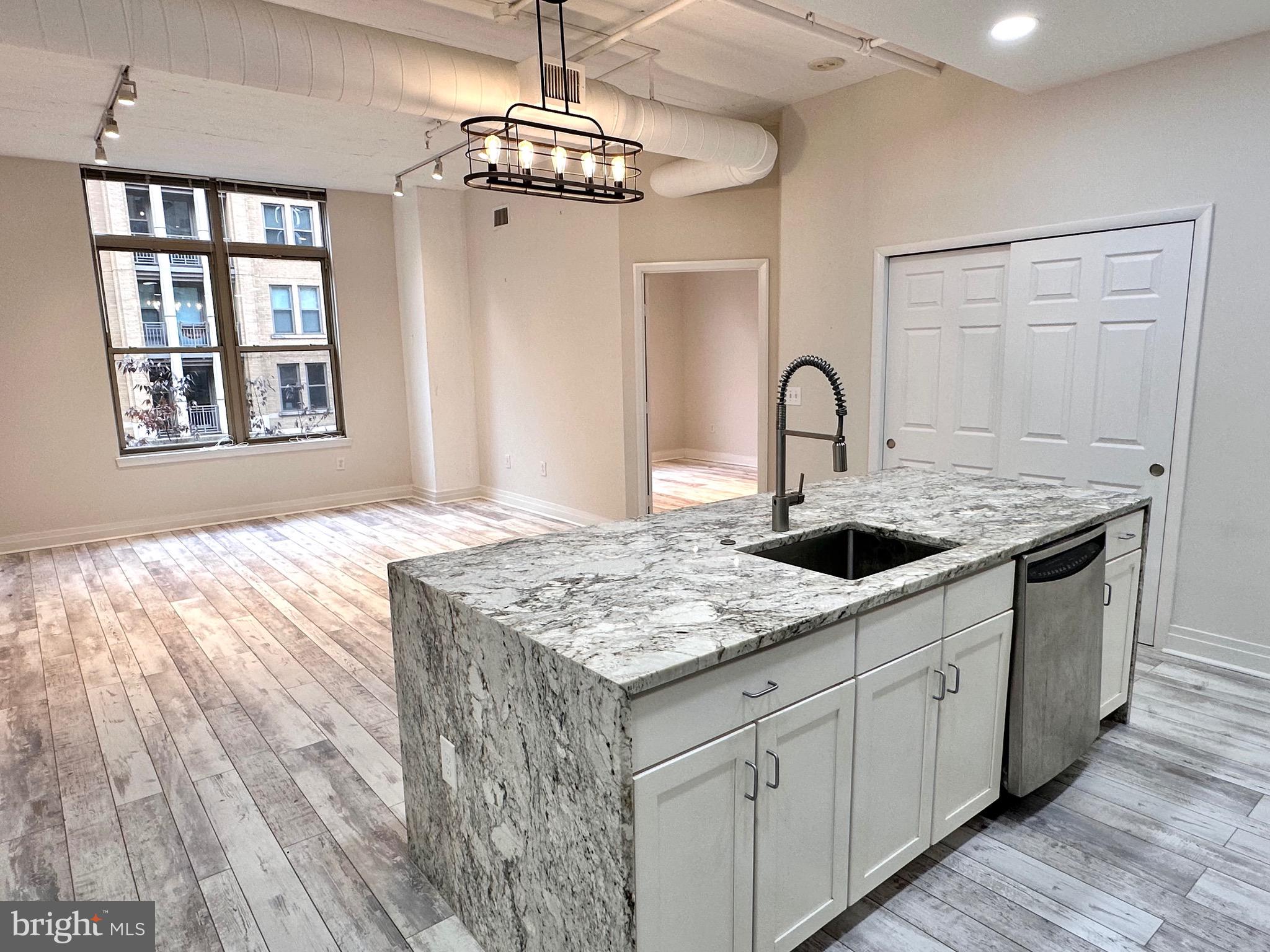 1201 North Garfield Street, Unit 408 Arlington, VA 22201 - Photo 26 of 26 a kitchen with a sink and chandelier