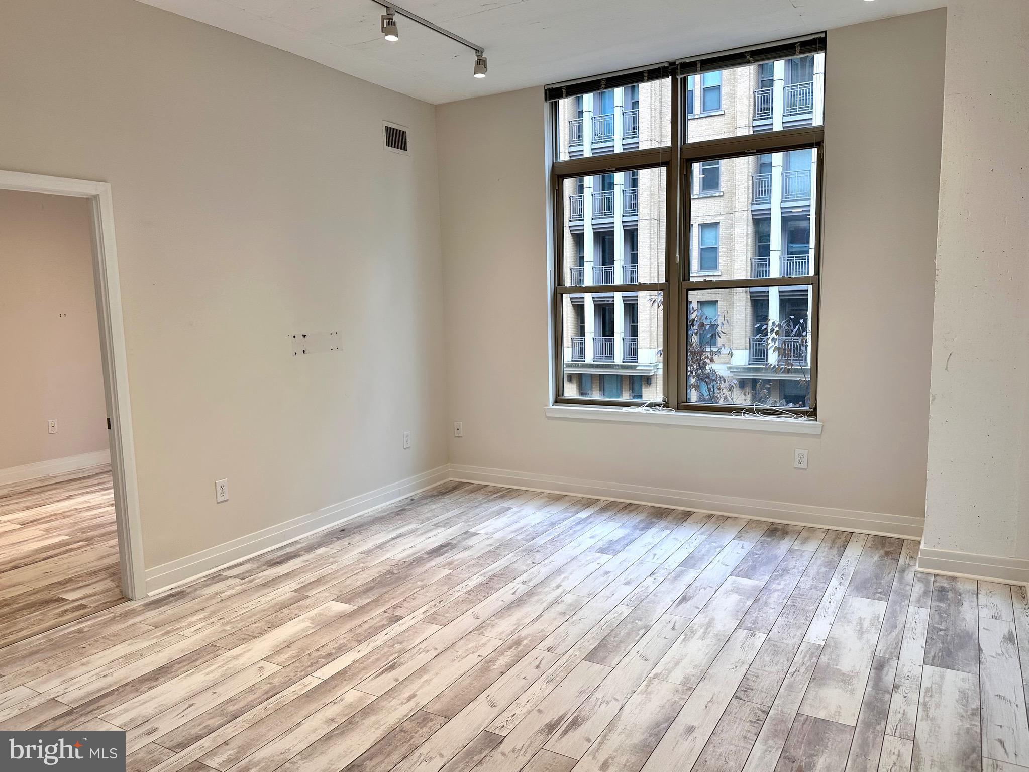 1201 North Garfield Street, Unit 408 Arlington, VA 22201 - Photo 6 of 26 a view of an empty room with wooden floor and a window