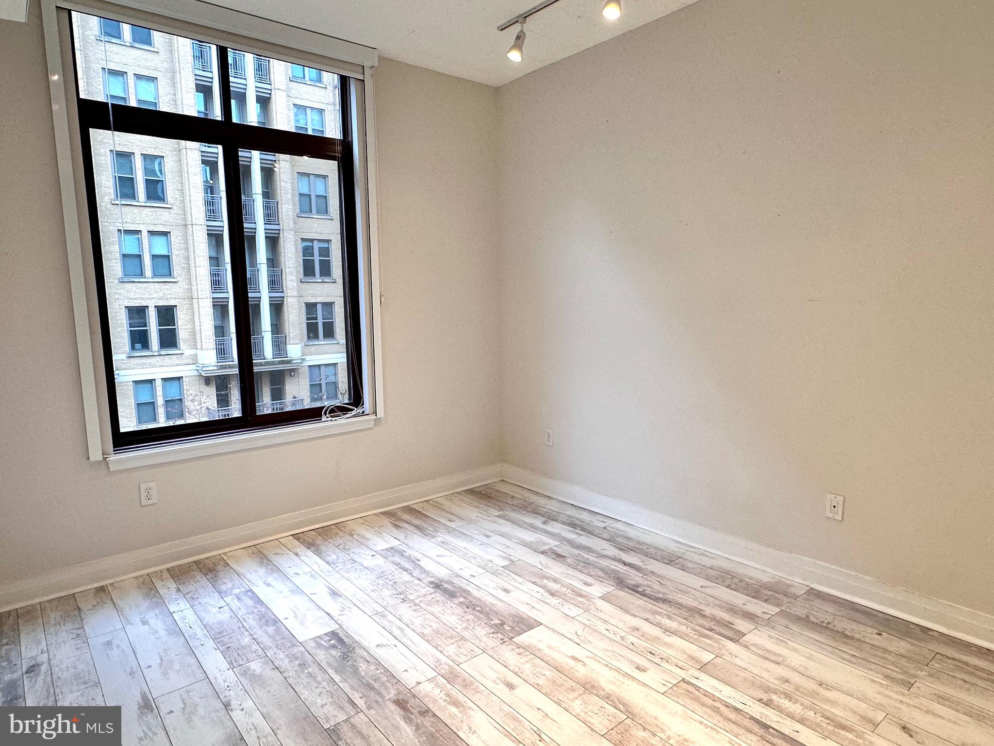 1201 North Garfield Street, Unit 408 Arlington, VA 22201 - Photo 7 of 26 a view of empty room with wooden floor and fan