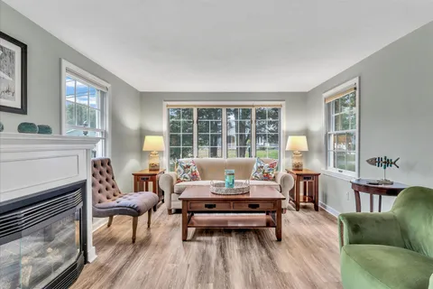 a view of a dining room with furniture large window and wooden floor