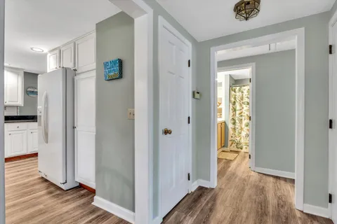 a kitchen with stainless steel appliances granite countertop a stove a sink and white cabinets