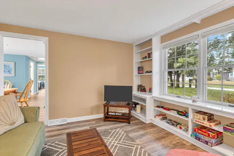 a kitchen with stainless steel appliances granite countertop a stove a sink a microwave a dining table and chairs