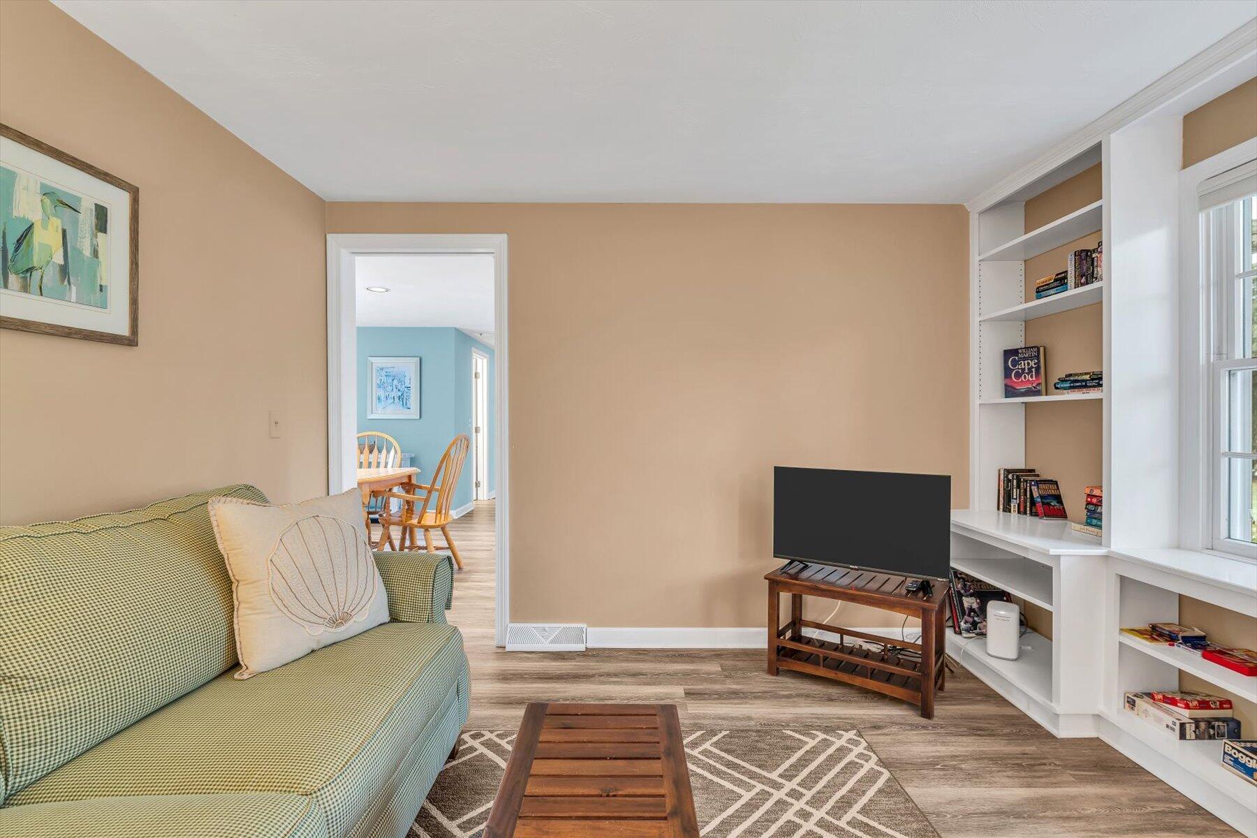30 Cove Road Eastham, MA 02642 - Photo 27 of 72 a living room with furniture and a book shelf