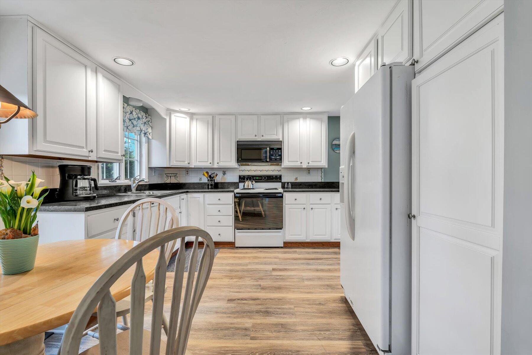 30 Cove Road Eastham, MA 02642 - Photo 34 of 72 a kitchen with granite countertop stainless steel appliances cabinets a sink and a counter top space