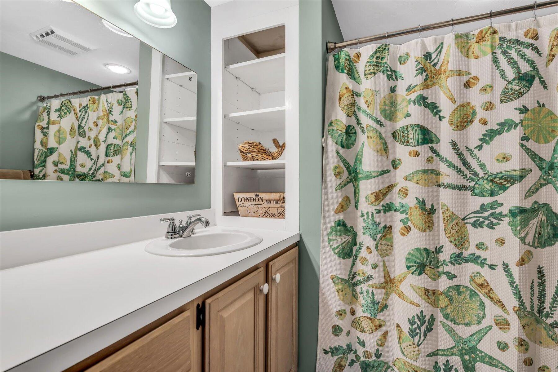 30 Cove Road Eastham, MA 02642 - Photo 39 of 72 a bathroom with a sink and a mirror