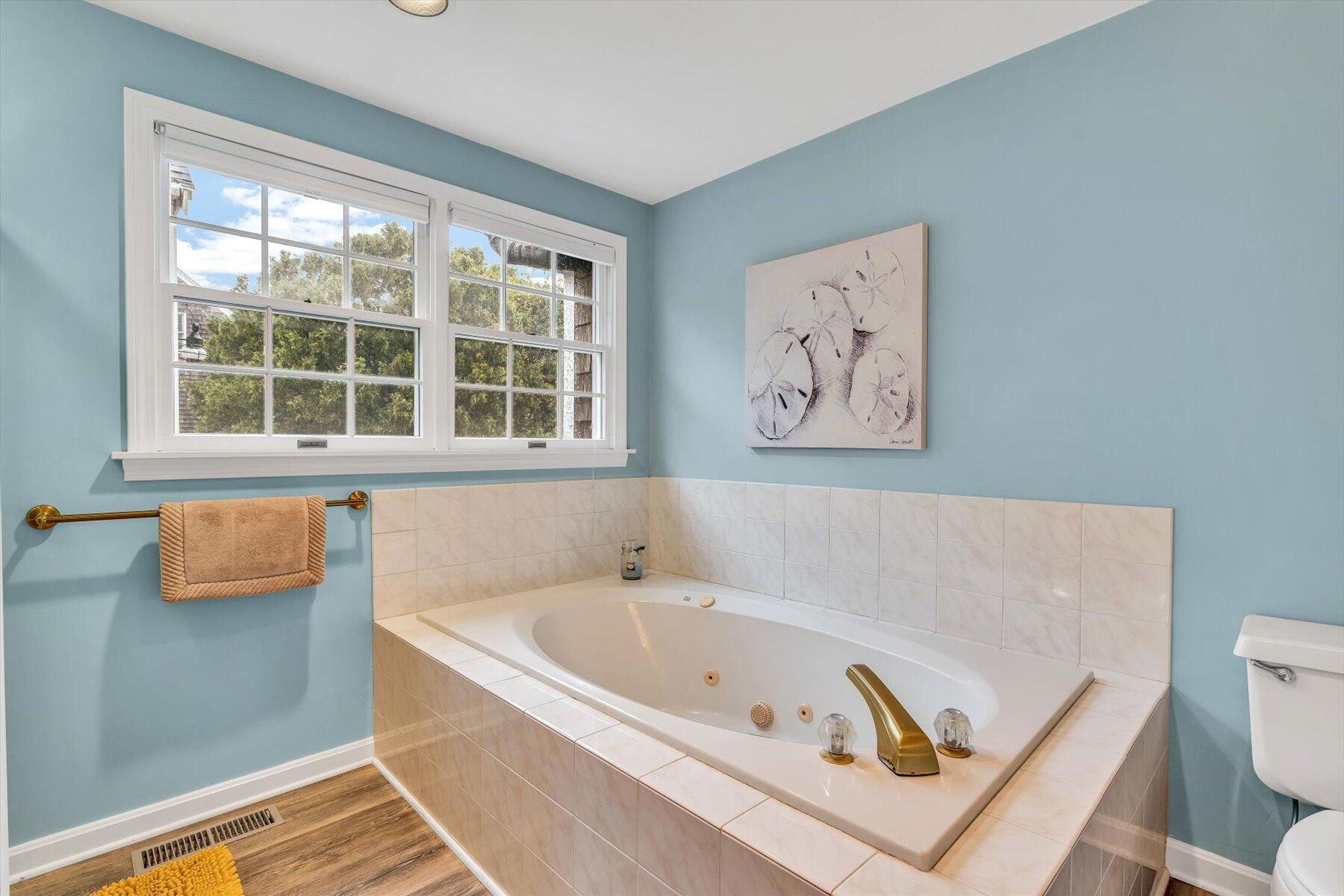 30 Cove Road Eastham, MA 02642 - Photo 47 of 72 a white bath tub sitting next to a window