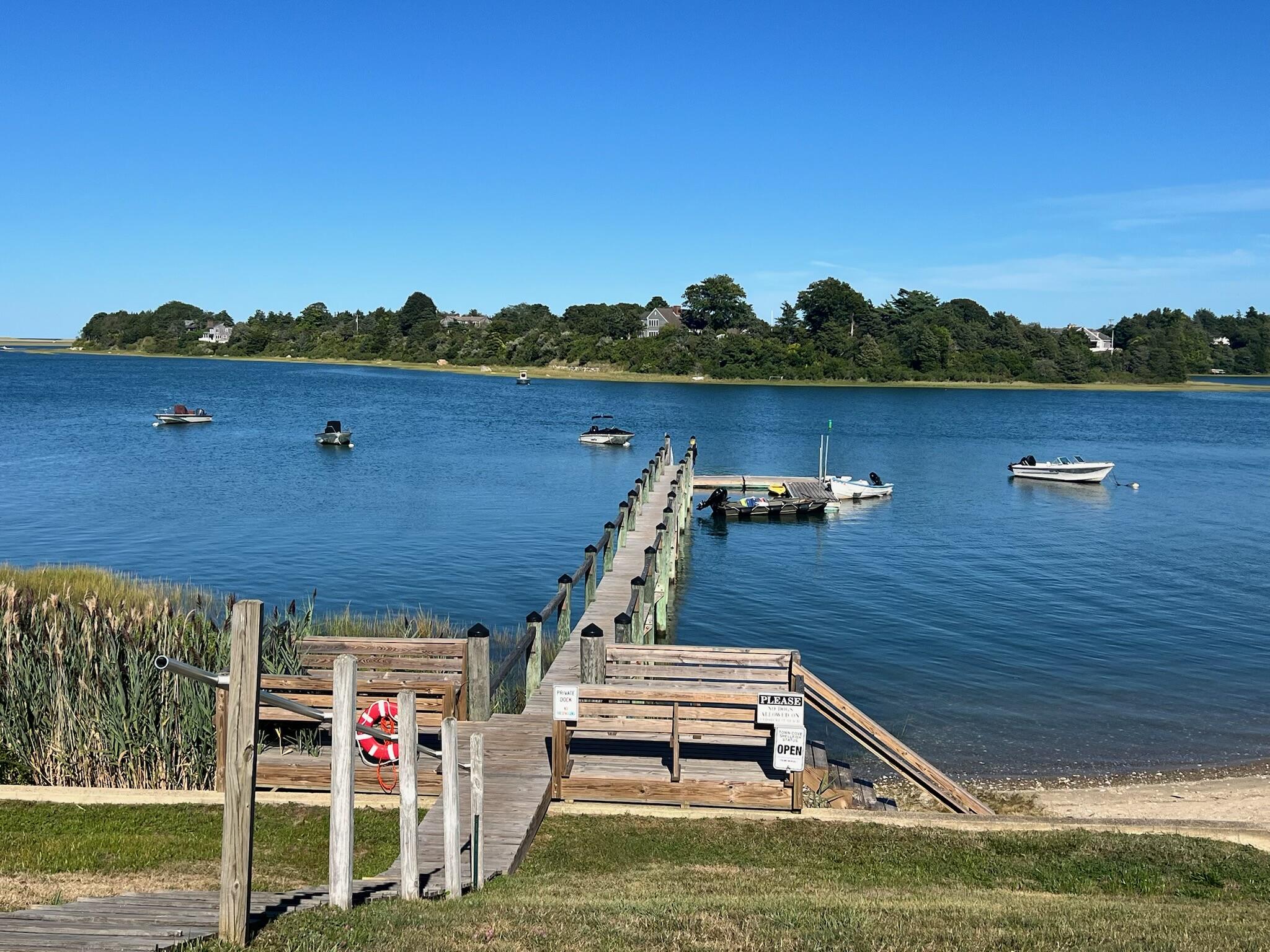 30 Cove Road Eastham, MA 02642 - Photo 9 of 72 a view of a lake with a big yard