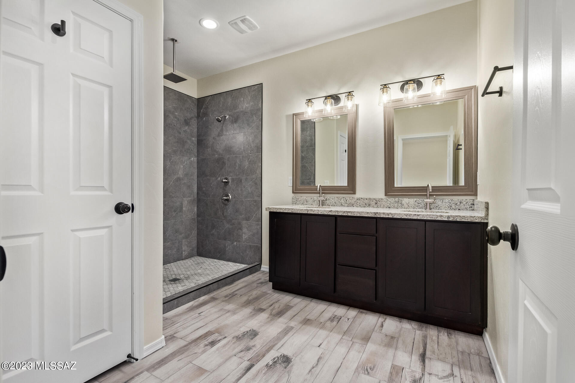 1795 Escobedo Court Rio Rico, AZ 85648 - Photo 18 of 30 a bathroom with a double vanity sink and mirror