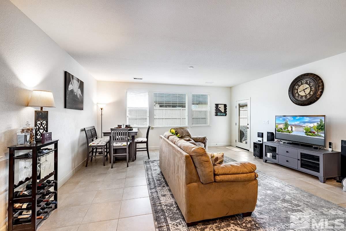 1824 Cholula Drive Reno, NV 89521 - Photo 3 of 17 a living room with furniture a wooden floor and a clock