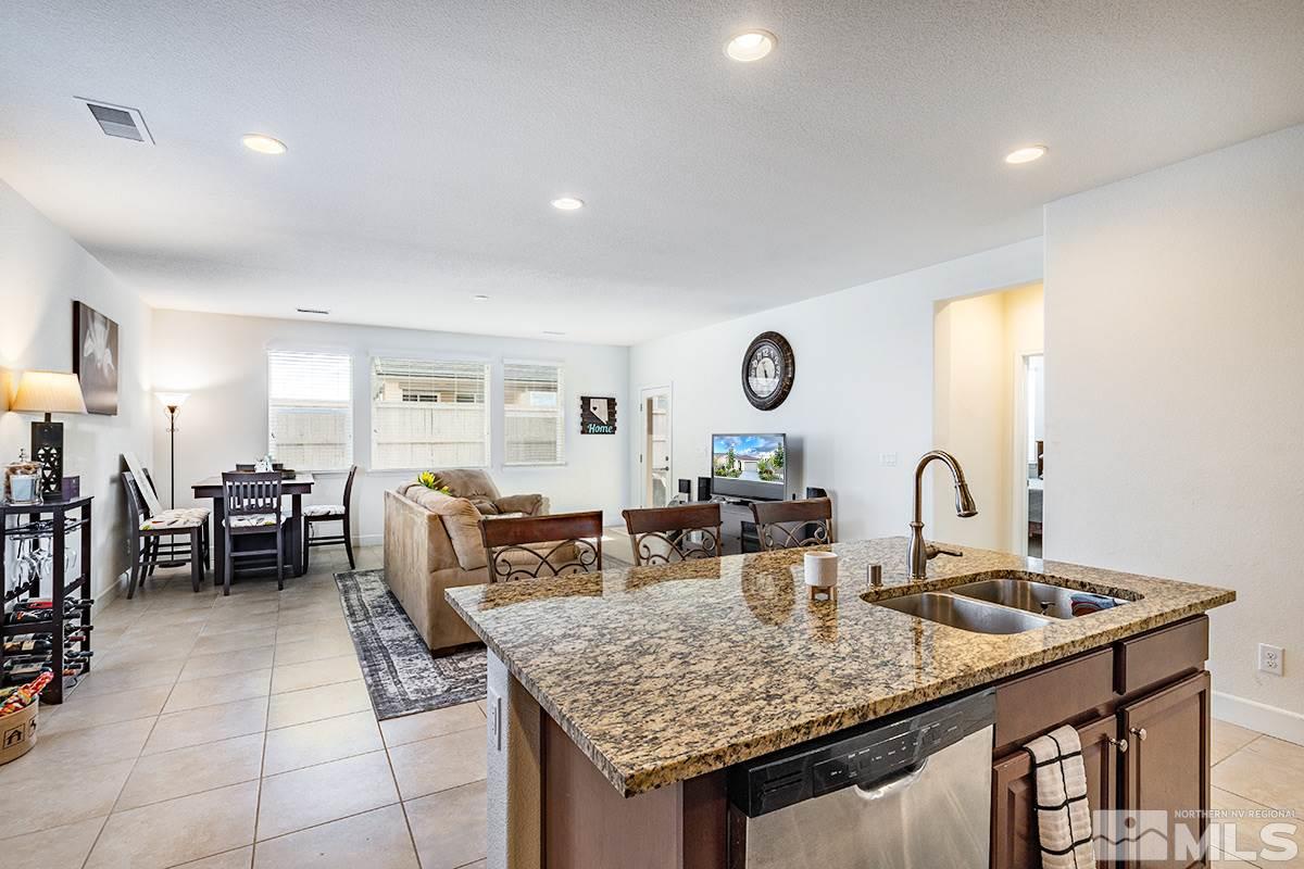 1824 Cholula Drive Reno, NV 89521 - Photo 8 of 17 a kitchen with granite countertop a table and chairs