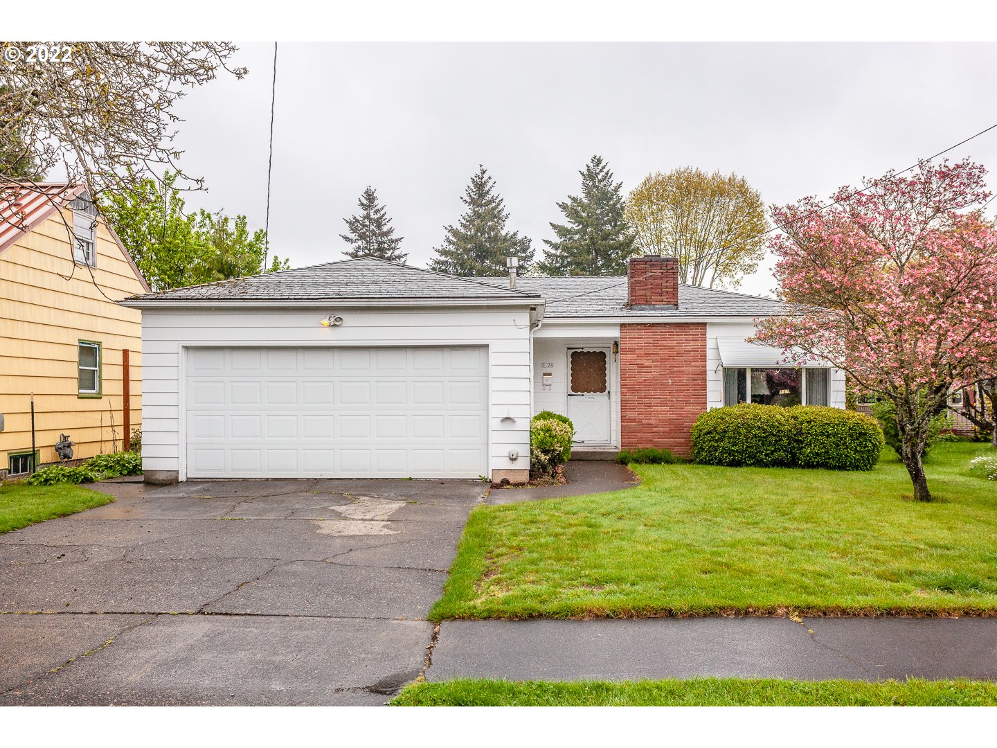 3124 Southeast 64th Avenue Portland, OR 97206 - Photo 1 of 22 a front view of a house with a yard and garage
