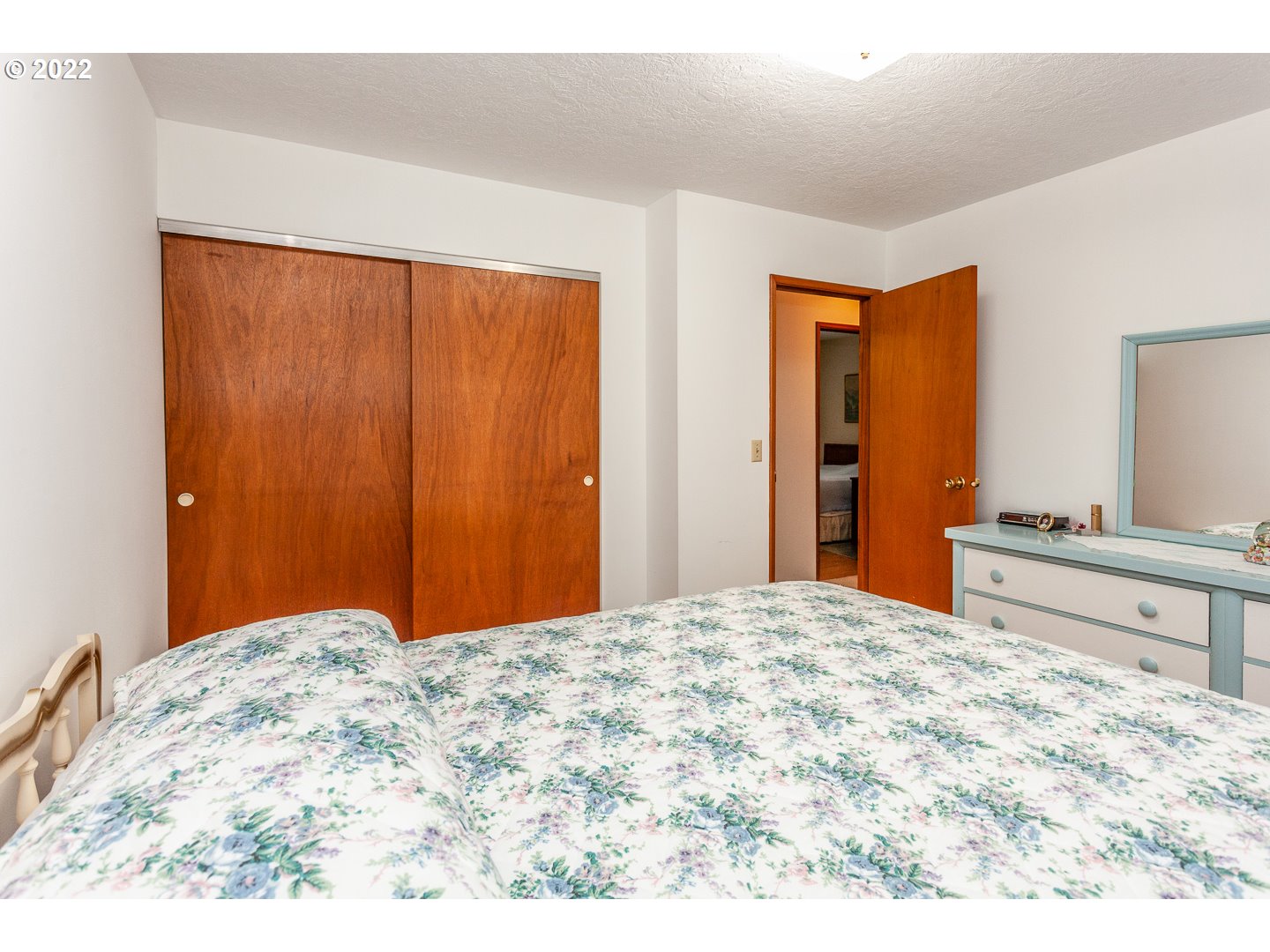 3124 Southeast 64th Avenue Portland, OR 97206 - Photo 16 of 22 a bedroom with a large bed and a dresser
