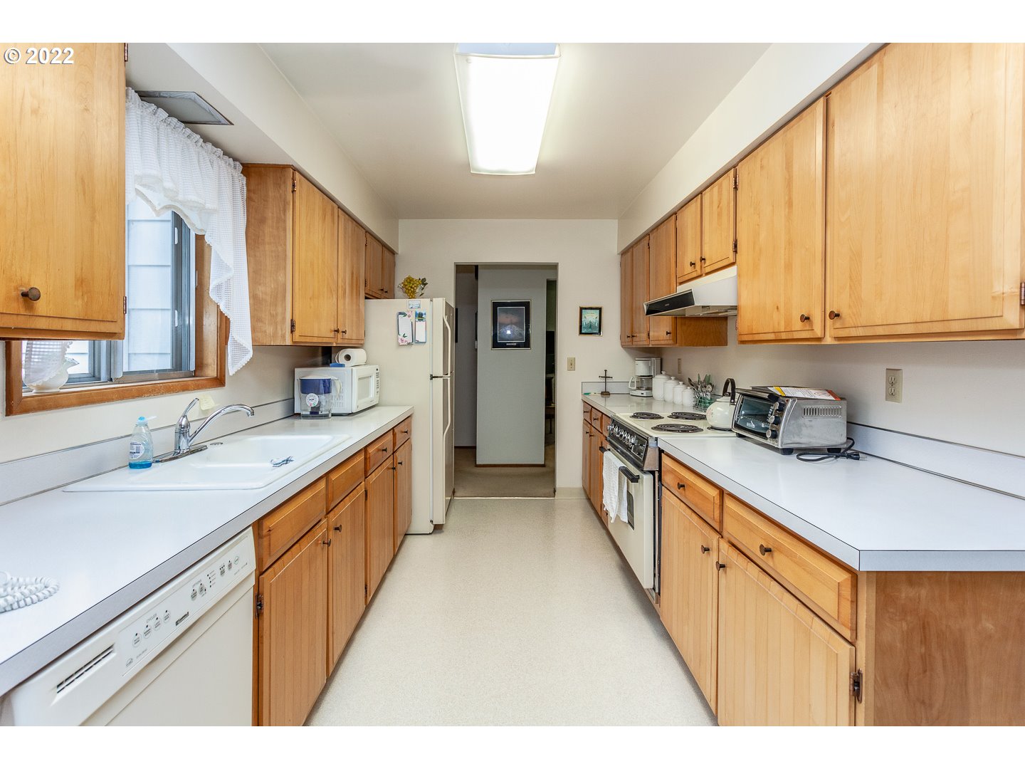 3124 Southeast 64th Avenue Portland, OR 97206 - Photo 5 of 22 a kitchen with stainless steel appliances granite countertop a sink and cabinets