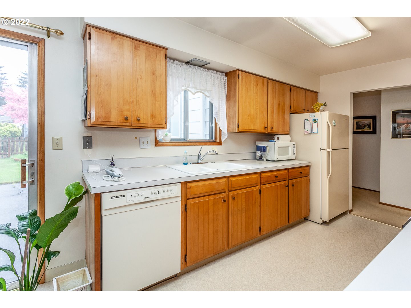 3124 Southeast 64th Avenue Portland, OR 97206 - Photo 6 of 22 a kitchen with appliances a sink cabinets and a window