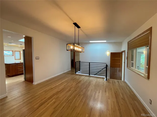 a spacious bedroom with a bed and a view of living room