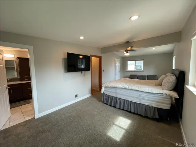 a spacious bedroom with a bed and a couch