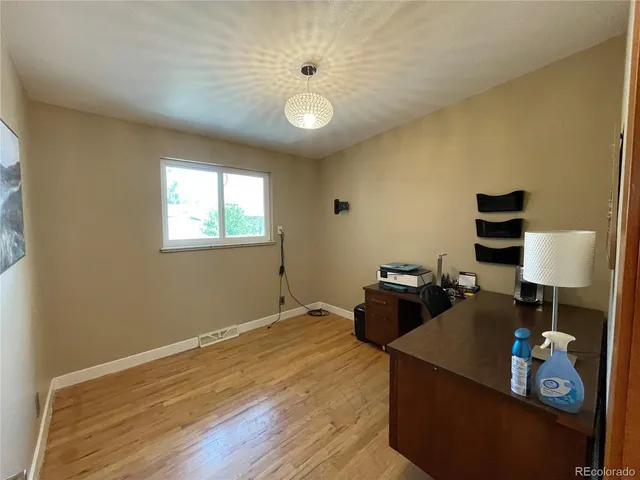 a bathroom with a granite countertop sink vanity and mirror