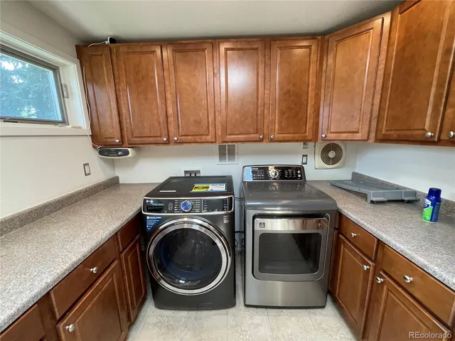 a kitchen with stainless steel appliances granite countertop a refrigerator a sink and wooden cabinets