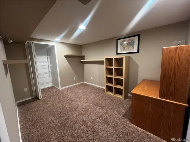 a bedroom with a bed and a mirror