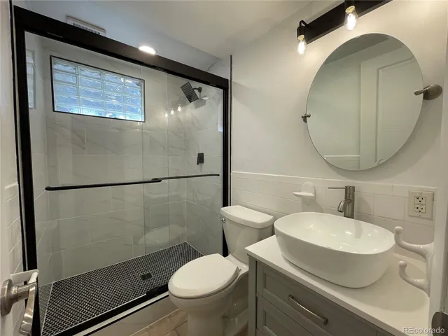 a large kitchen with stainless steel appliances a sink and a stove