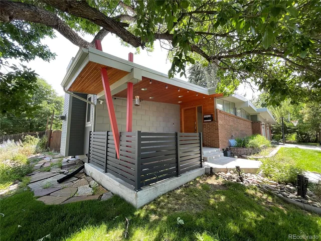 a backyard of a house with a garden and plants
